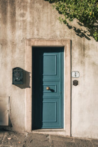 A blue wooden door set into a stone building