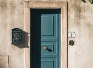 A blue wooden door set into a stone building