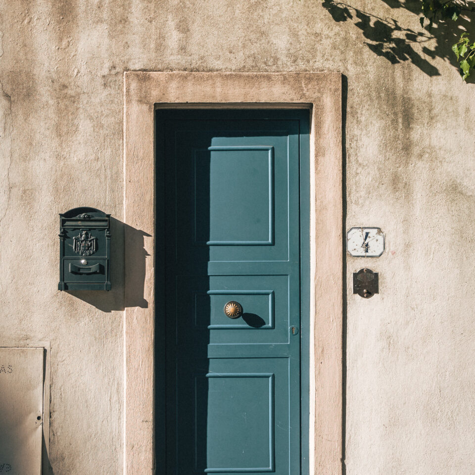 A blue wooden door set into a stone building